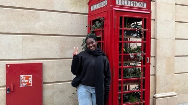 Ebony with a red telephone box in London