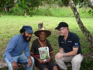 Professor John Waiko  and Dr Jonathan Ritchie, with Mr Hawala Laula, 89, who carried supplies dropped by allied aircraft for the Australian soldiers around Kagi village.