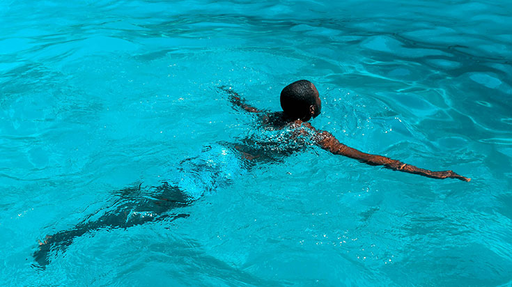 A student swimming in a pool