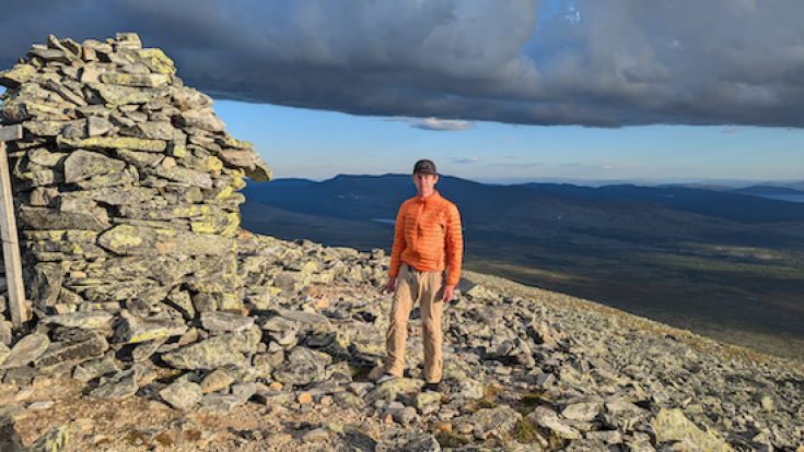 Student Charlie stands on top of rocky mountain in Netherlands