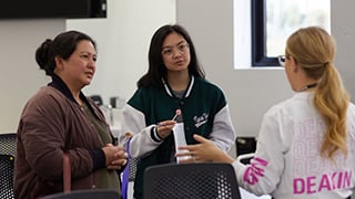  High school student and parent listening to course advice from a Deakin staff member