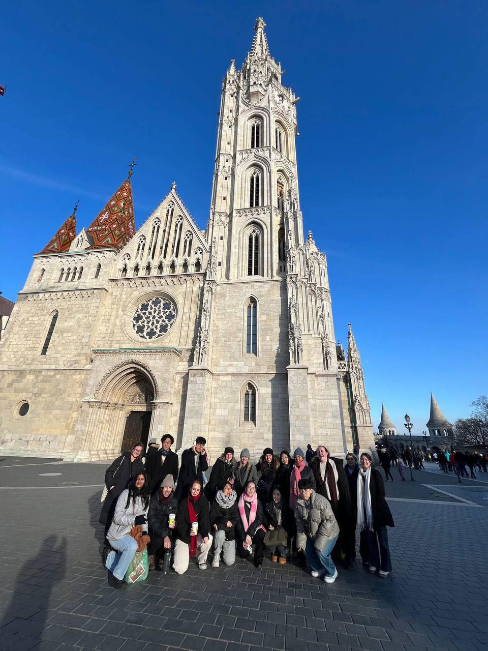 A group of students standing in front of a cathedral in Budapest
