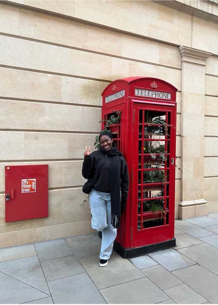Ebony with a red telephone box in London