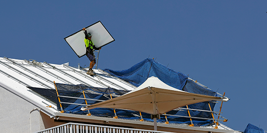 Person working on roof on sunny day