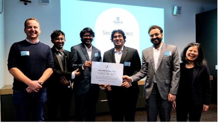 Group of 6 people smiling with certificate